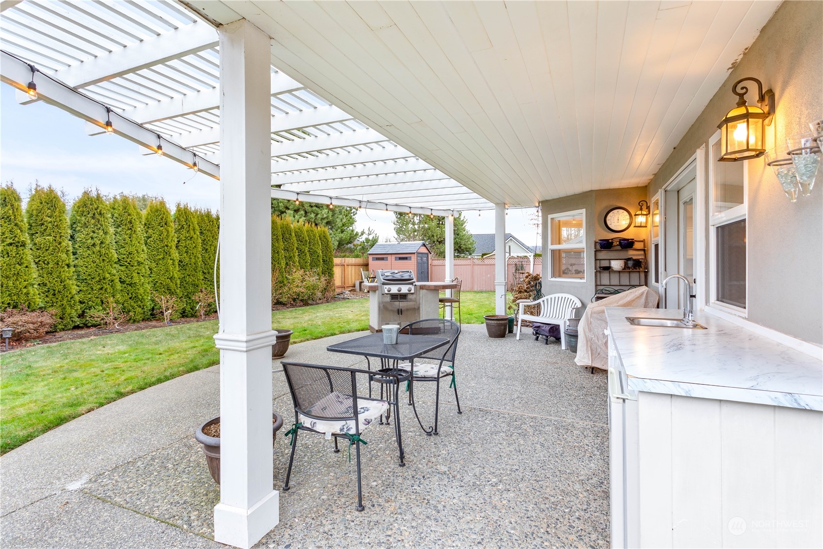212 Springview Drive Lynden, WA 98264 - Photo 31 of 40 a view of an outdoor dining space with a table and chairs