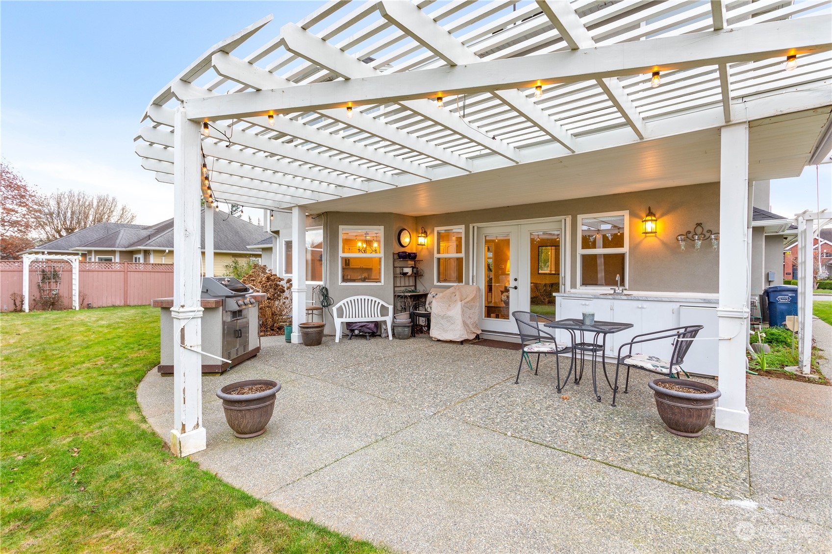 212 Springview Drive Lynden, WA 98264 - Photo 32 of 40 a view of a patio with table and chairs near a barbeque