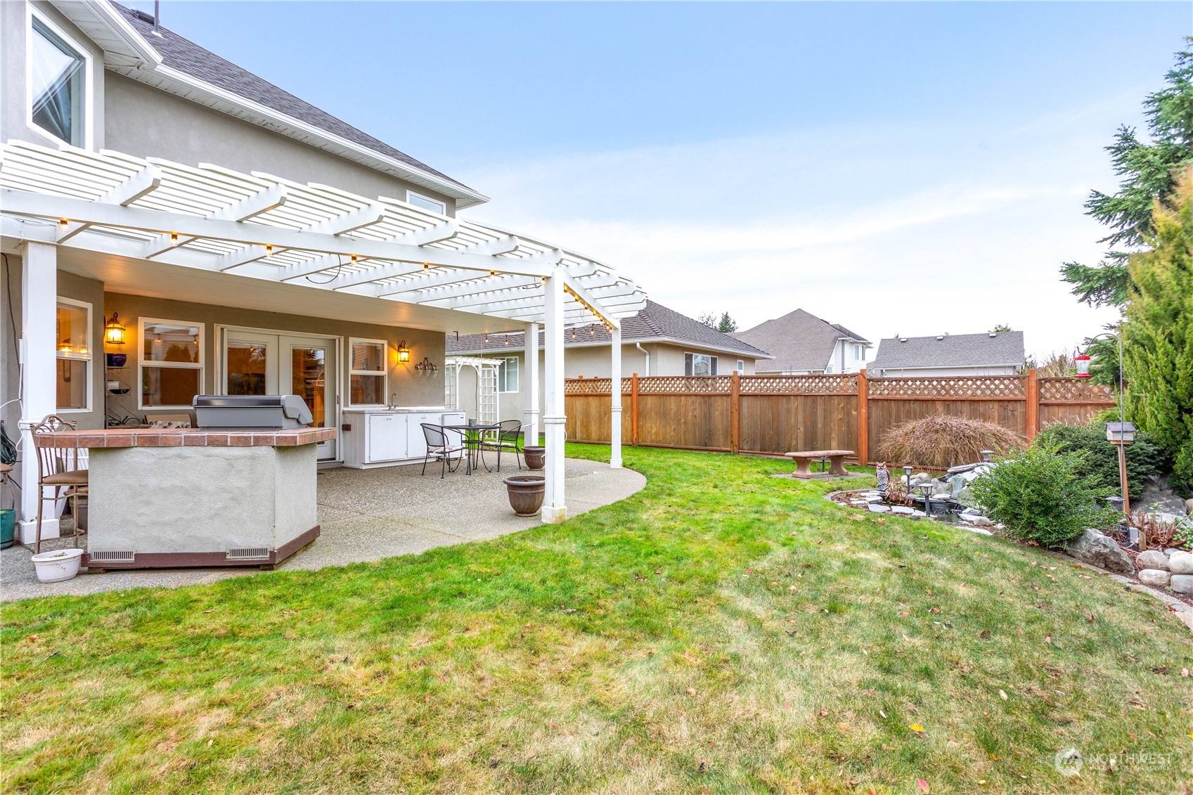 212 Springview Drive Lynden, WA 98264 - Photo 34 of 40 a view of a patio with table and chairs and potted plants