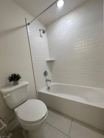 a bathroom with a toilet and a bath tub