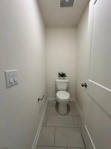 a white toilet sitting next to a white sink