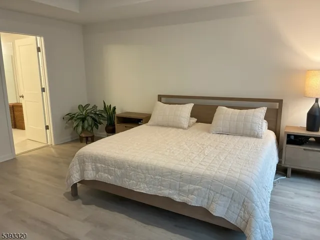 a bedroom with a bed table and a couch