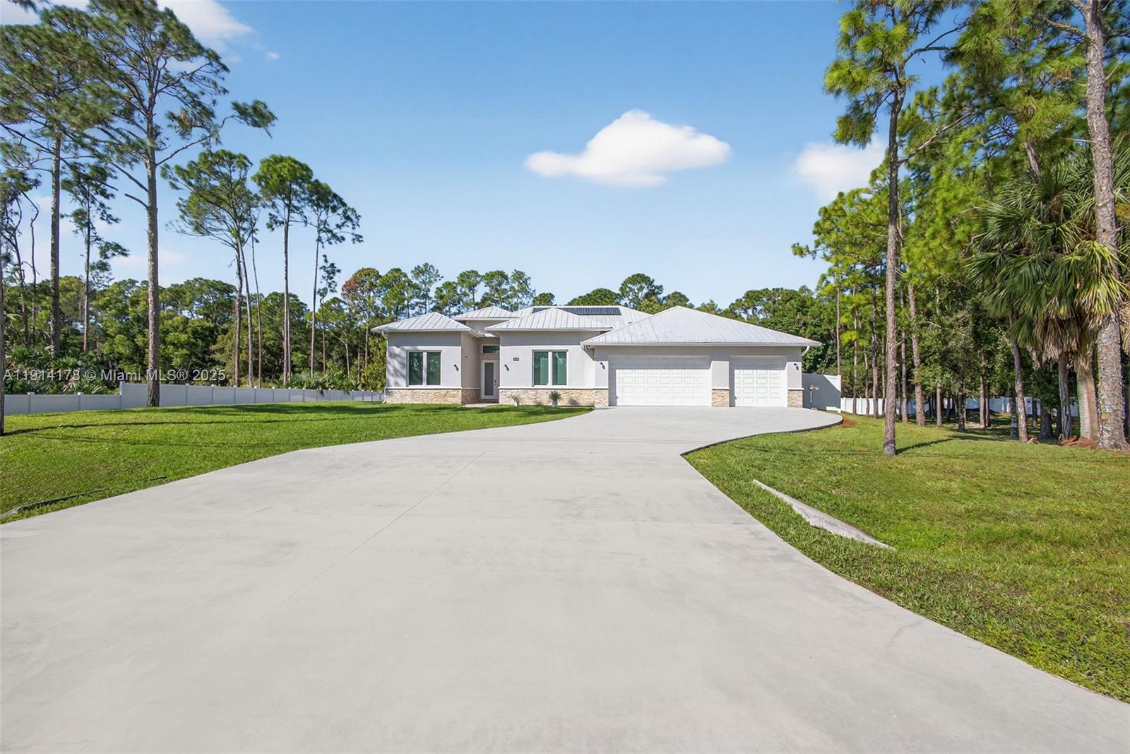 18369 Mellen Lane Jupiter, FL 33478 - Photo 1 of 84 a front view of house with yard and green space