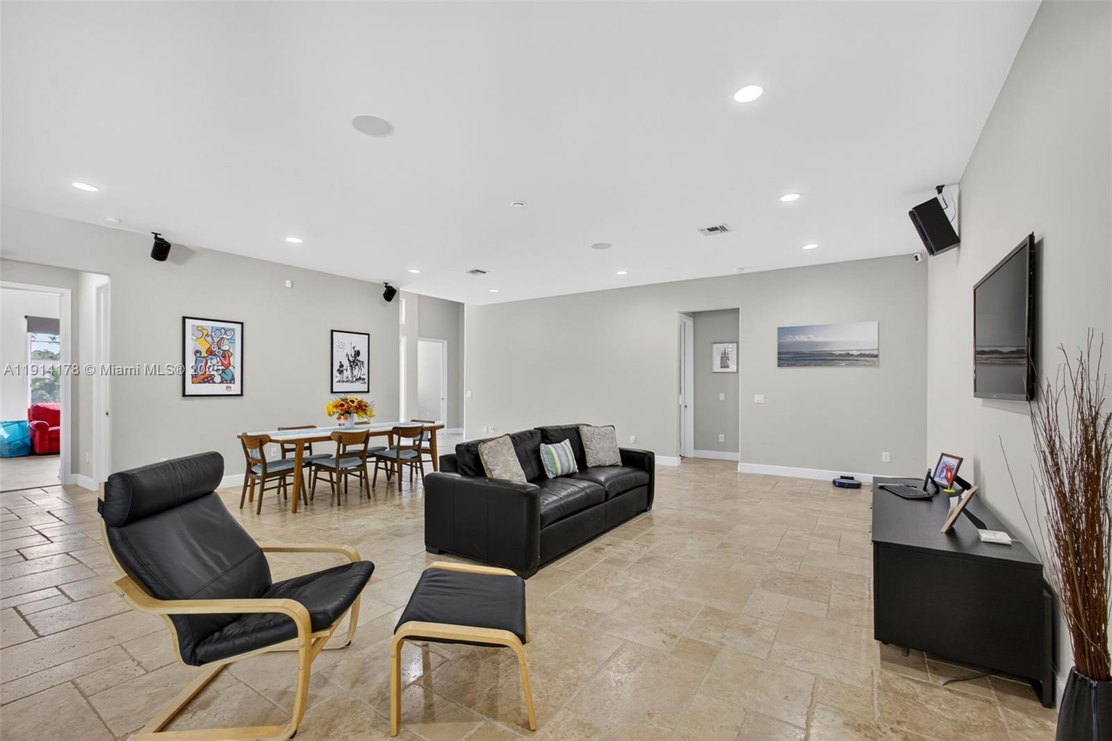 18369 Mellen Lane Jupiter, FL 33478 - Photo 11 of 84 a living room with furniture and a flat screen tv