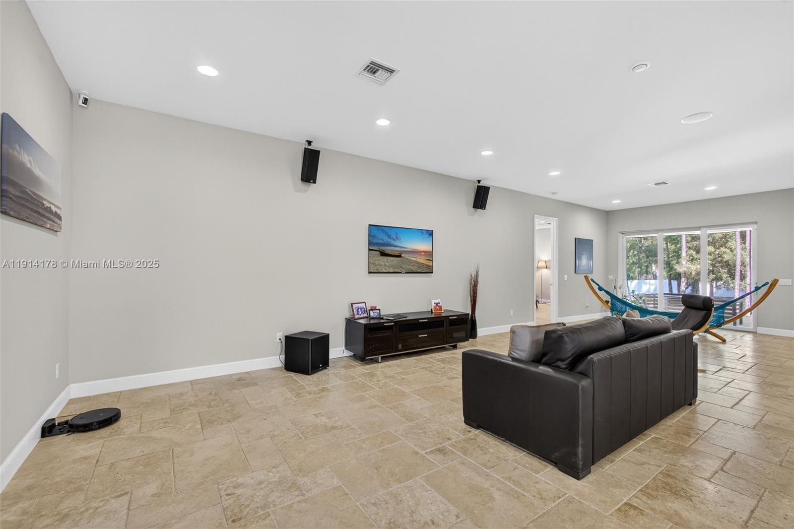 18369 Mellen Lane Jupiter, FL 33478 - Photo 13 of 84 a living room with furniture and a gym machine