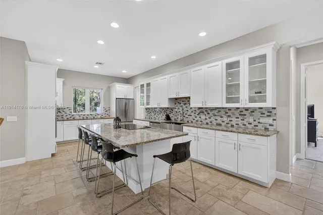 a kitchen with a stove sink and cabinets