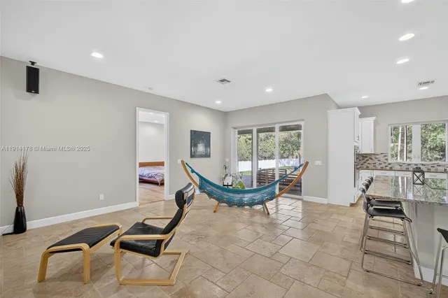 a kitchen with stainless steel appliances kitchen island granite countertop a sink and cabinets
