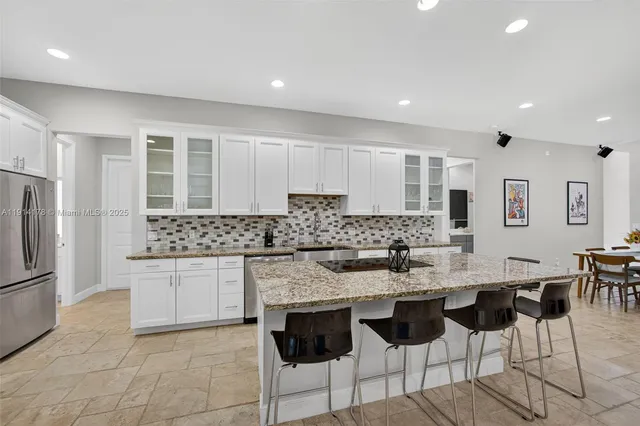 a bedroom with a large bed a flat tv screen and a closet