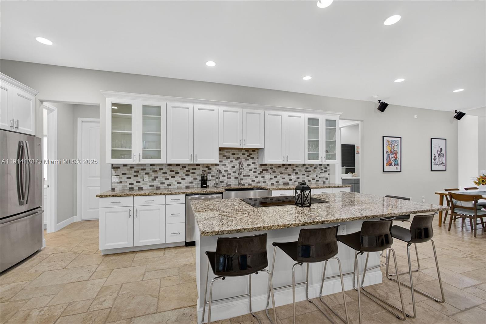 18369 Mellen Lane Jupiter, FL 33478 - Photo 20 of 84 a kitchen with granite countertop a sink and cabinets