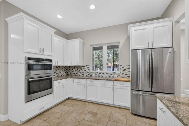 a bathroom with a tub a sink double vanity and mirror