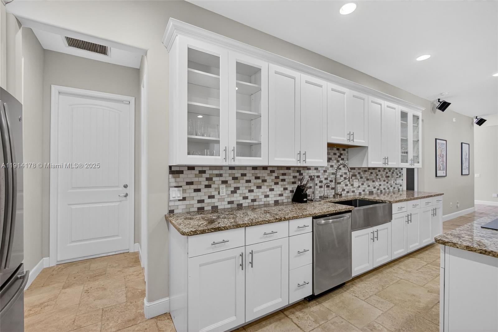 18369 Mellen Lane Jupiter, FL 33478 - Photo 25 of 84 a kitchen with stainless steel appliances granite countertop a sink and cabinets