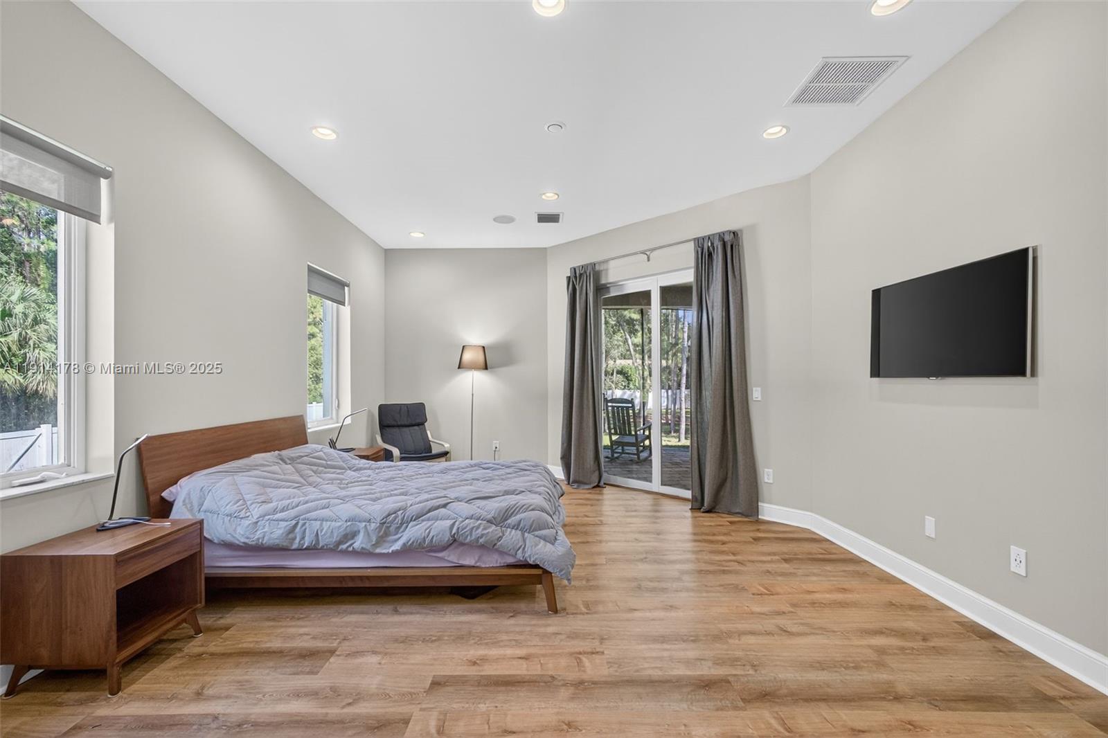 18369 Mellen Lane Jupiter, FL 33478 - Photo 27 of 84 a bedroom with a bed and a flat screen tv