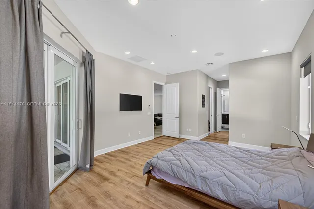 a spacious bedroom with a bed and a window