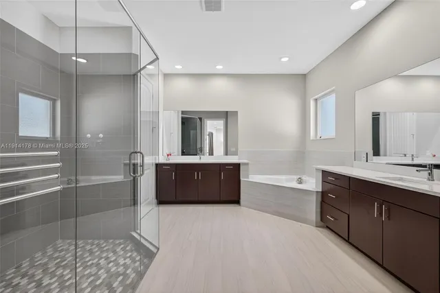 a spacious bathroom with a sink toilet vanity and tub