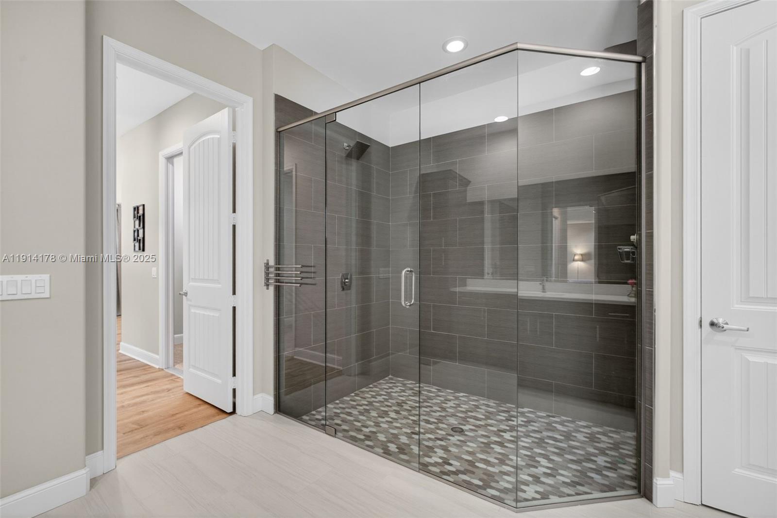 18369 Mellen Lane Jupiter, FL 33478 - Photo 33 of 84 a bathroom that has a glass shower door