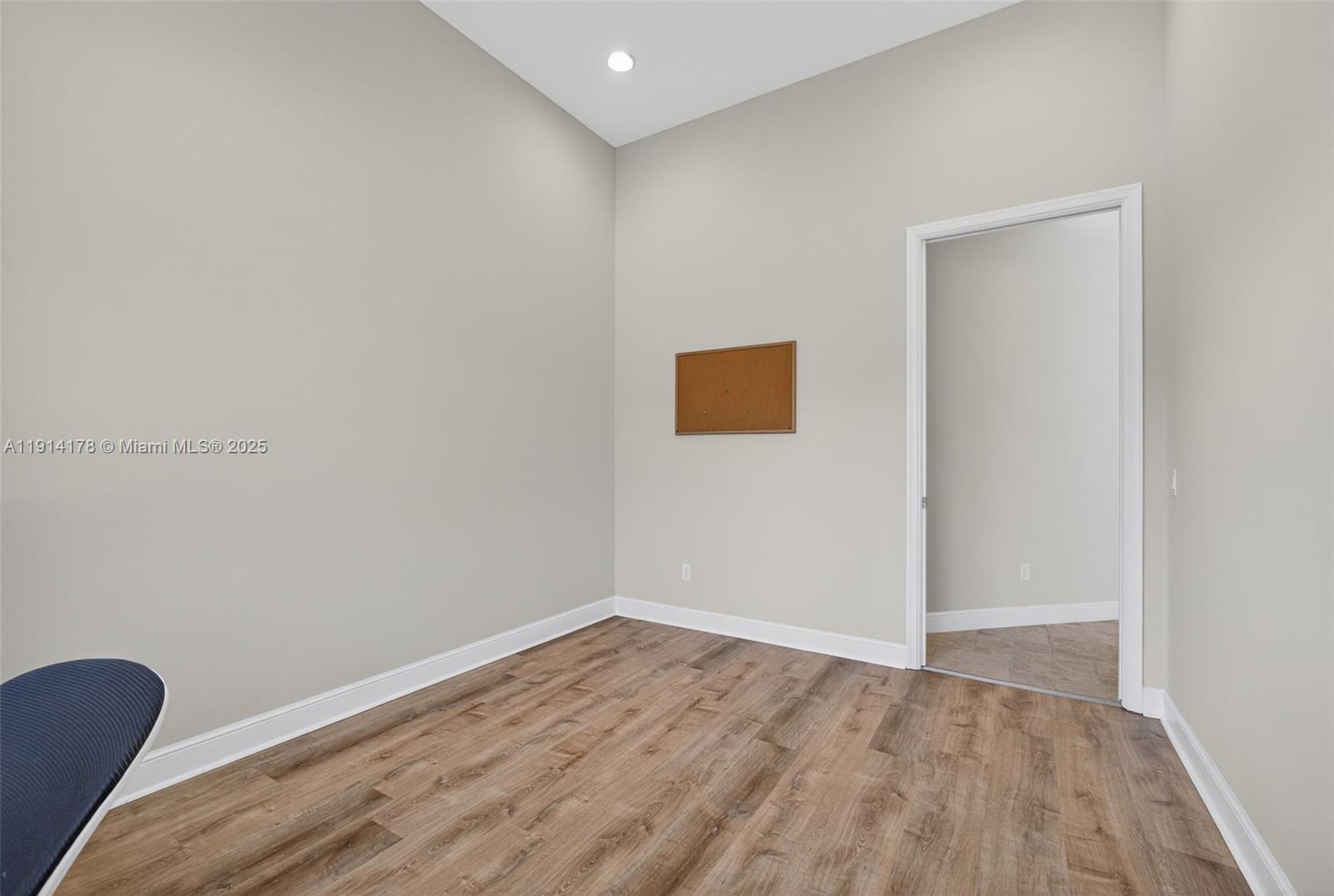 18369 Mellen Lane Jupiter, FL 33478 - Photo 35 of 84 a view of an empty room with wooden floor