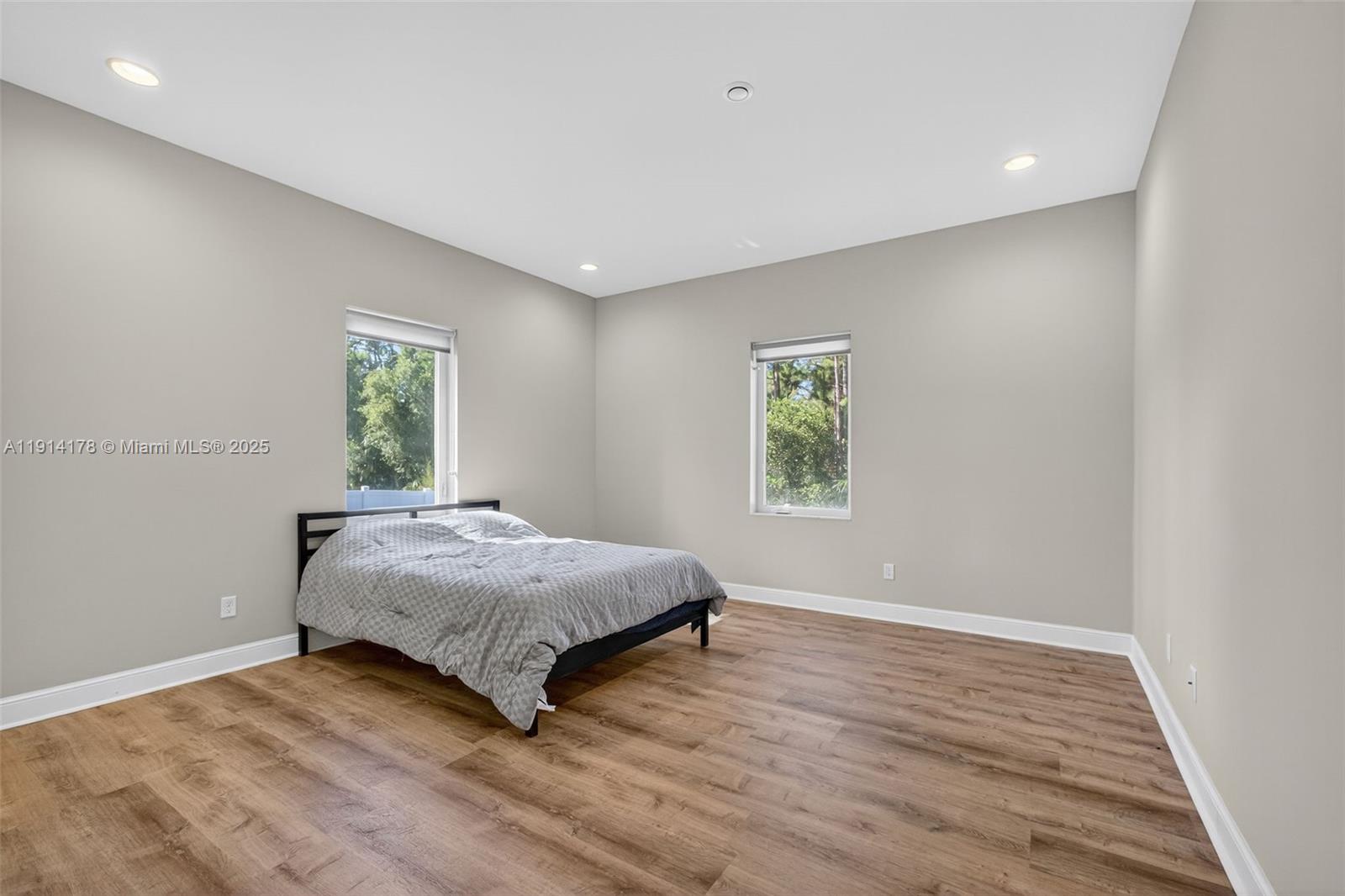 18369 Mellen Lane Jupiter, FL 33478 - Photo 40 of 84 a spacious bedroom with a bed and a window