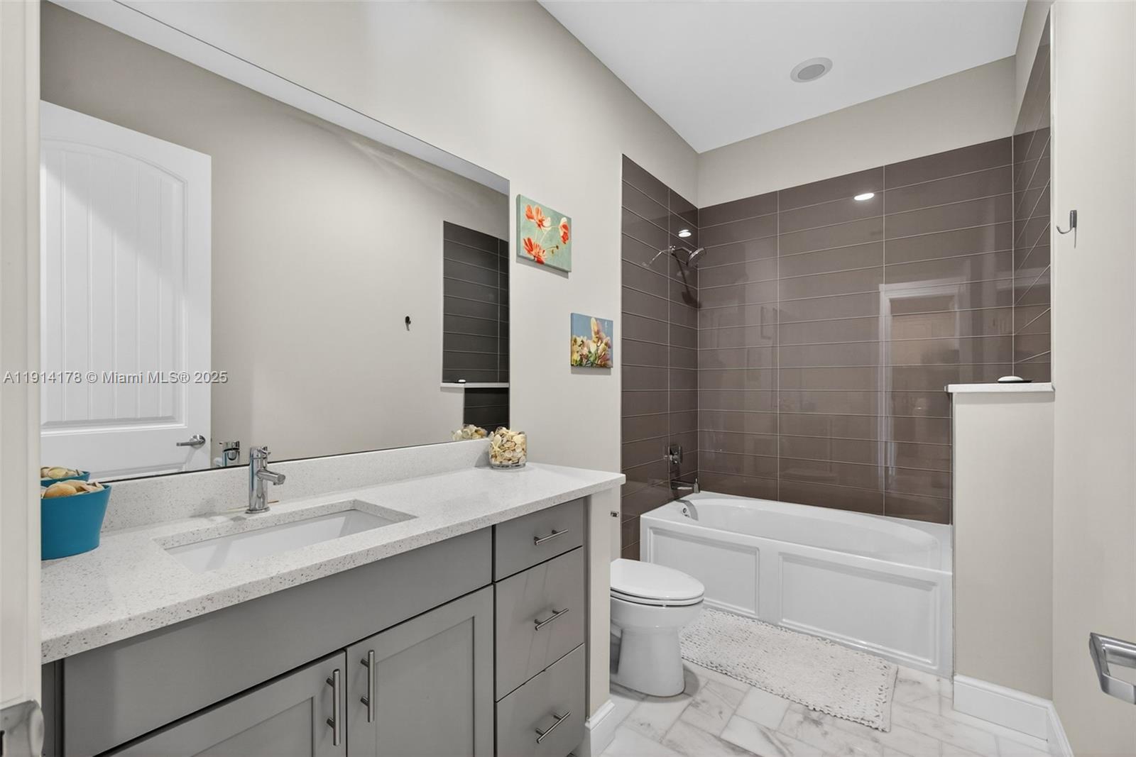 18369 Mellen Lane Jupiter, FL 33478 - Photo 42 of 84 a bathroom with a granite countertop sink a toilet and shower