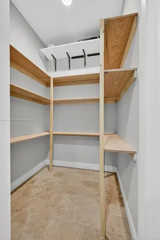 an aerial view of a residential houses with a yard and lake