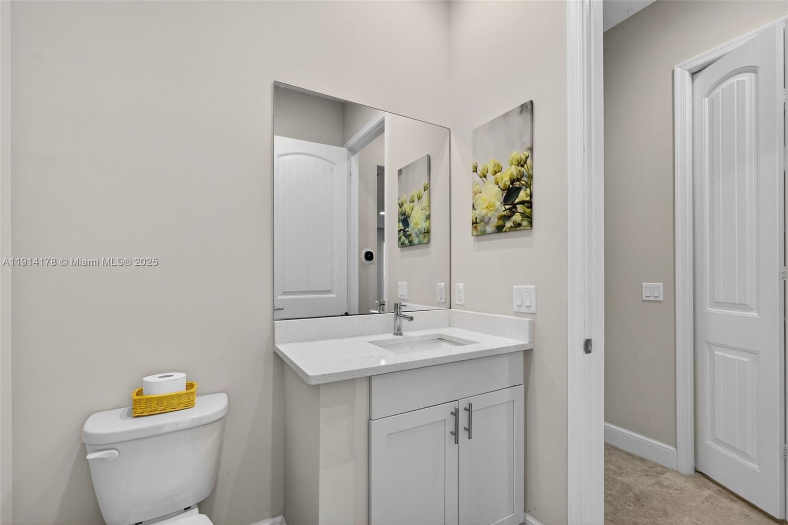 18369 Mellen Lane Jupiter, FL 33478 - Photo 50 of 84 a bathroom with a toilet sink and mirror
