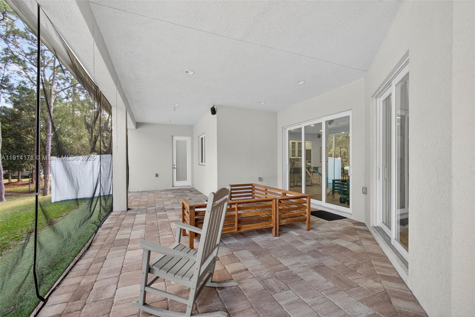 18369 Mellen Lane Jupiter, FL 33478 - Photo 53 of 84 a living room with furniture and a floor to ceiling window