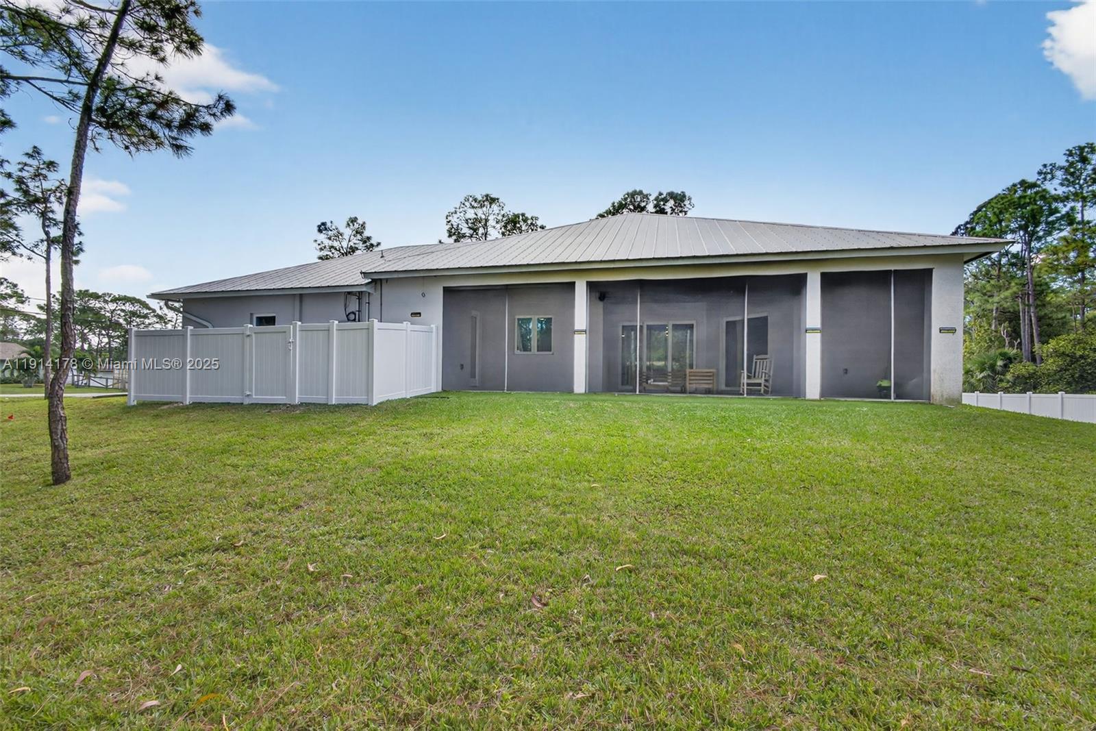 18369 Mellen Lane Jupiter, FL 33478 - Photo 60 of 84 a front view of a house with garden