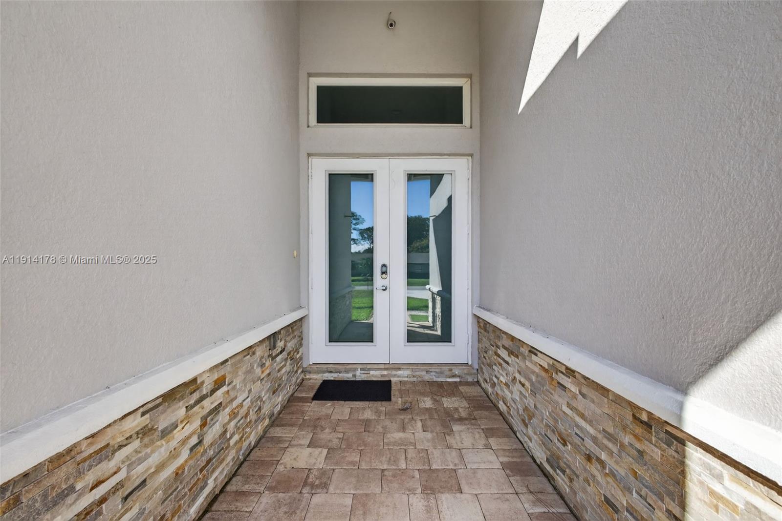 18369 Mellen Lane Jupiter, FL 33478 - Photo 7 of 84 a view of a hallway with wooden floor and a fireplace