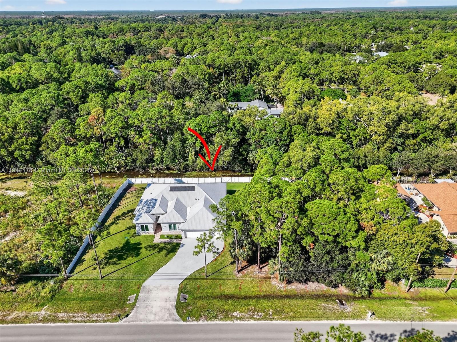18369 Mellen Lane Jupiter, FL 33478 - Photo 72 of 84 an aerial view of a house with a yard