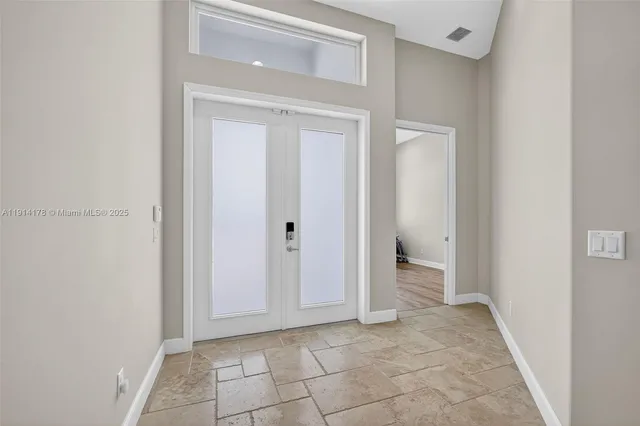 a living room with furniture and a gym machine