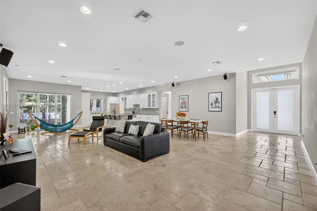 a living room with patio furniture and a large window