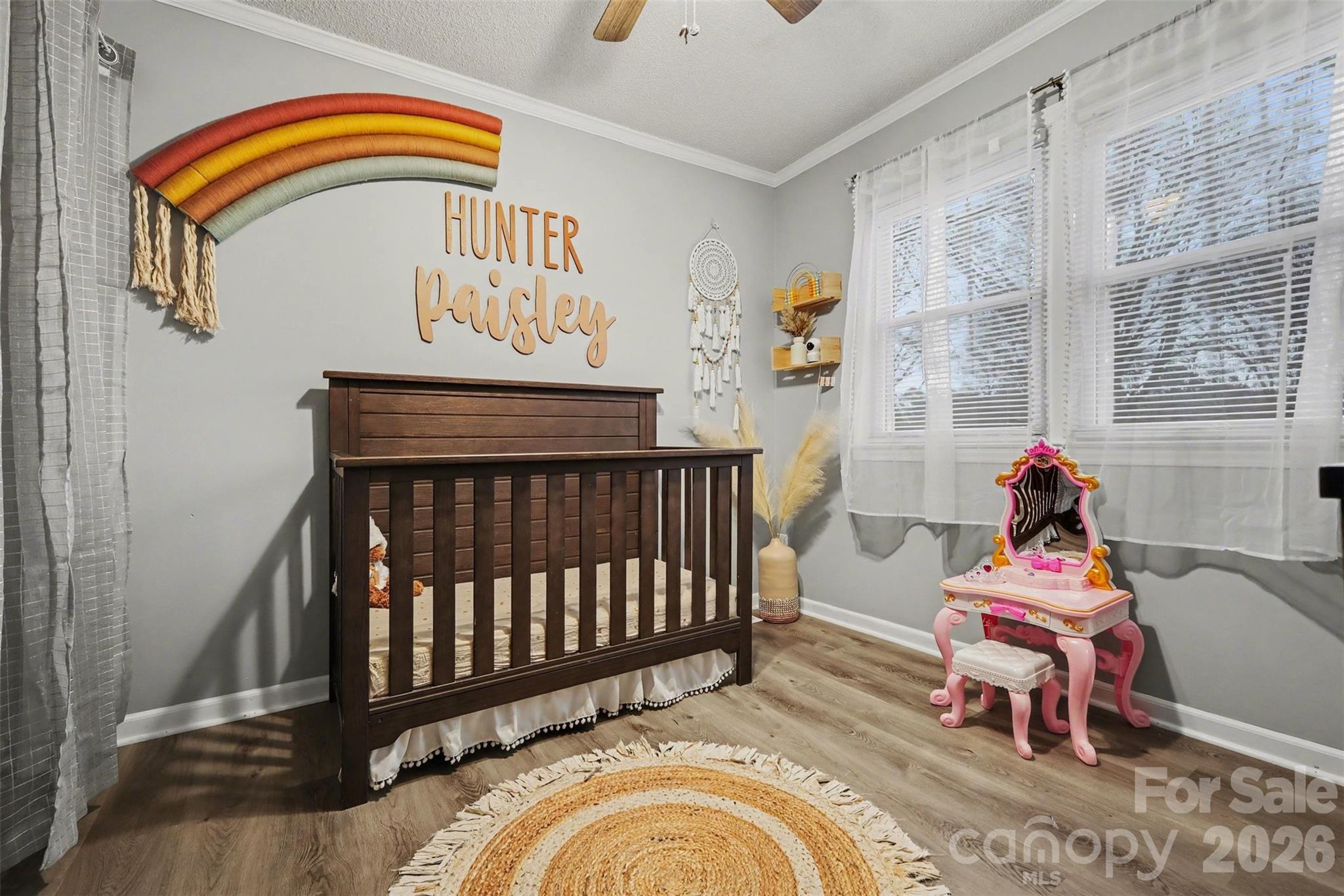 1008 Edgewood Road Bessemer City, NC 28016 - Photo 10 of 26 a bedroom with a baby bed a couch and dresser
