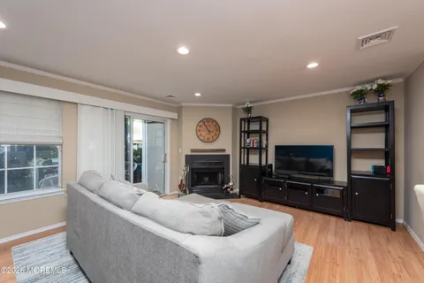 a living room with fireplace furniture and a flat screen tv
