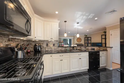 a kitchen with a sink stove and cabinets