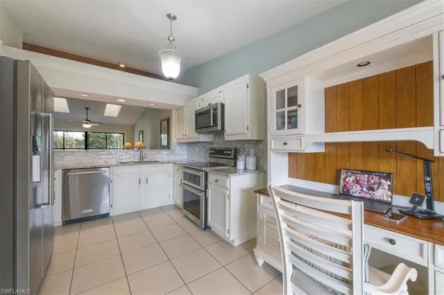 a kitchen with a stove a sink and a refrigerator