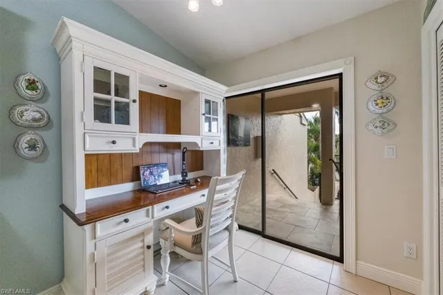 a dining room with furniture and a window