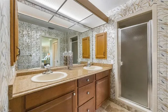 a bathroom with a sink double vanity and a mirror
