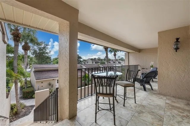 a view of a chairs and table in the balcony