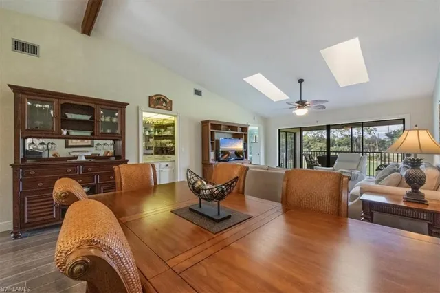 a living room with furniture fireplace and a large window