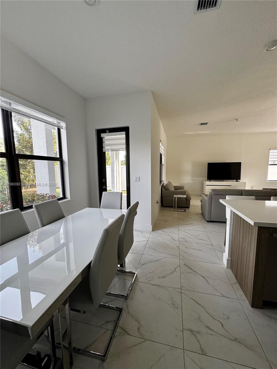 4409 Southwest 173rd Avenue Miramar, FL 33029 - Photo 14 of 38 a living room with furniture a fireplace and large windows
