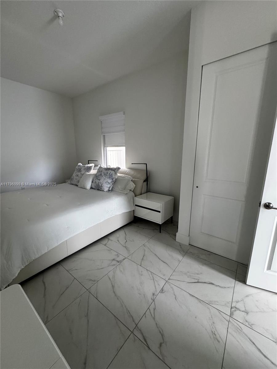 4409 Southwest 173rd Avenue Miramar, FL 33029 - Photo 15 of 38 a bedroom with a bed and a cabinets