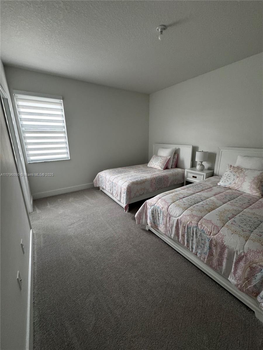 4409 Southwest 173rd Avenue Miramar, FL 33029 - Photo 29 of 38 a bedroom with two beds and a window