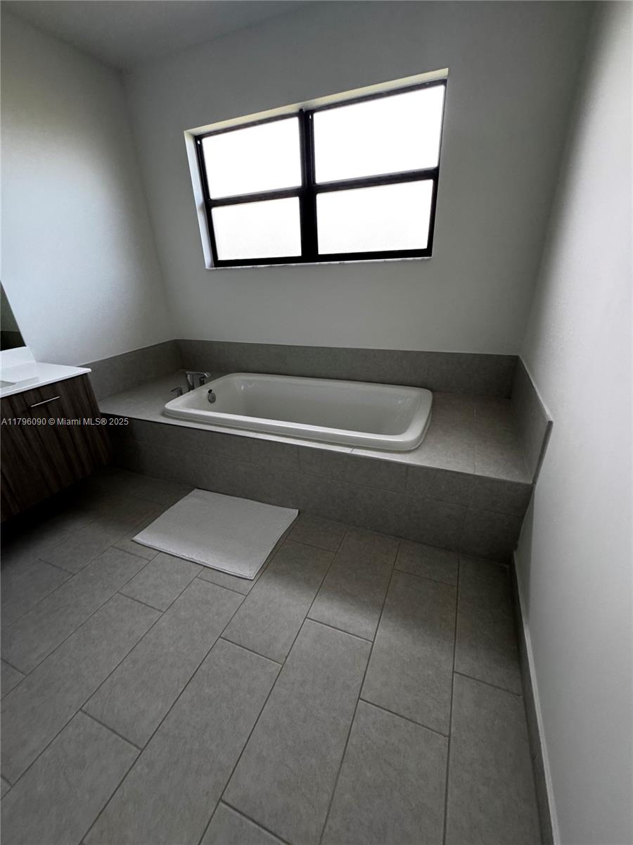 4409 Southwest 173rd Avenue Miramar, FL 33029 - Photo 38 of 38 a bathroom with a bathtub and a window