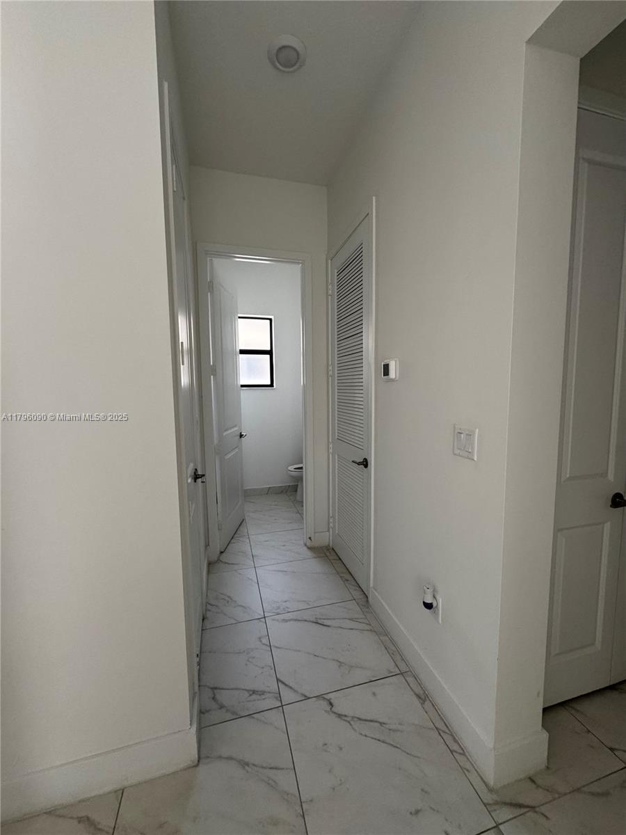 4409 Southwest 173rd Avenue Miramar, FL 33029 - Photo 5 of 38 a view of a hallway to rooms