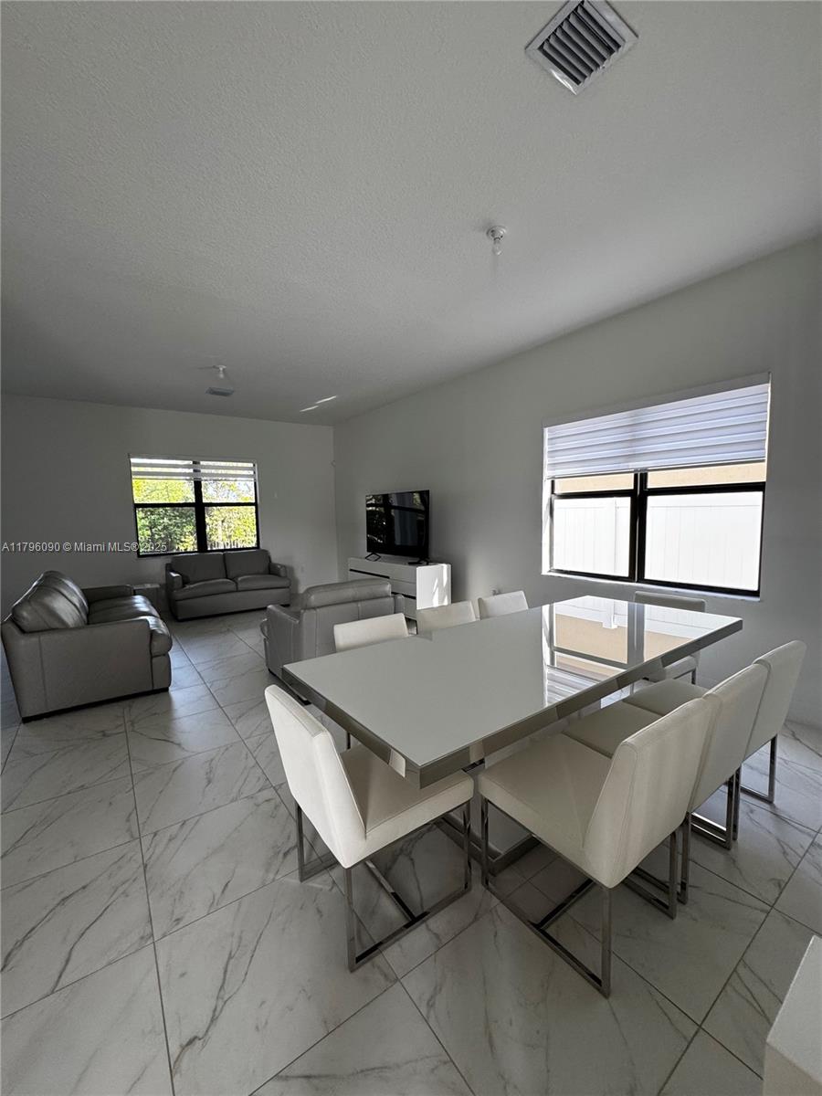 4409 Southwest 173rd Avenue Miramar, FL 33029 - Photo 8 of 38 a living room with furniture a window and a table