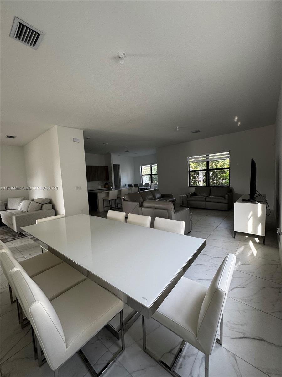 4409 Southwest 173rd Avenue Miramar, FL 33029 - Photo 9 of 38 a living room with furniture and view of kitchen
