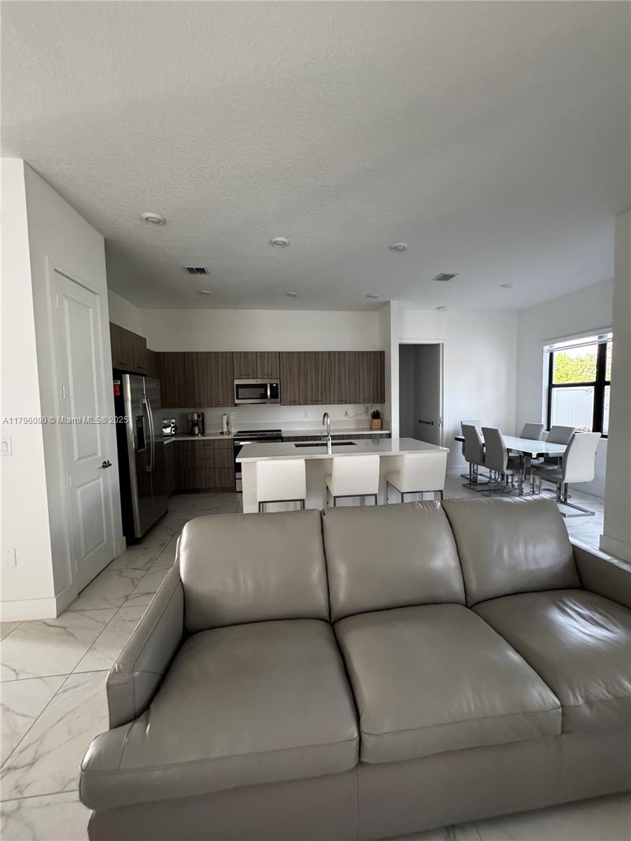 4409 Southwest 173rd Avenue Miramar, FL 33029 - Photo 10 of 38 a living room with furniture and a couch