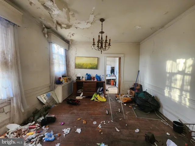 a living room with furniture a window and a chandelier