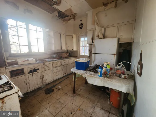 a kitchen with a sink cabinets and appliances