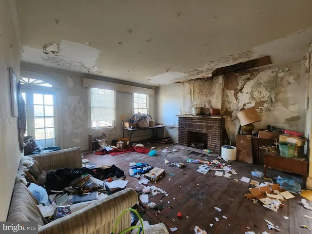 a living room with furniture a fireplace and a window