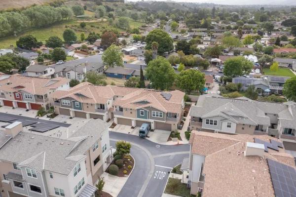 an aerial view of residential houses with outdoor space
